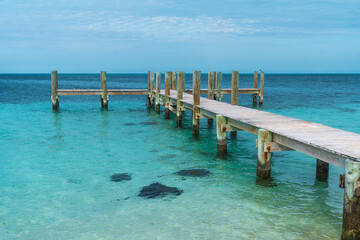 Wood dock over clear turquoise water